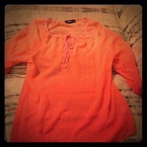 An ombré peach to pink shirt